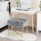 Gray faux fur ottoman stool with golden metal legs, perfect for bedroom or living room decor and compact spaces.