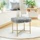 Gray faux fur decorative stool with golden metal legs, providing a stylish touch and comfort for small spaces.