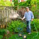 Wheeled hose reel cart with steel frame, holding 200 feet of hose, ideal for garden and landscaping use.