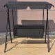 Cushioned black loveseat swing glider with steel frame and canopy, ideal for outdoor relaxation in gardens or patios.