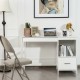 Modern white computer desk with a side view highlighting the footrest and stylish decorative items for an inviting.