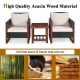 Two acacia wood frame sofas with beige cushions and a coffee table, perfect for outdoor patio relaxation.