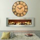 27-inch round wooden wall clock with metal Roman numerals, perfect for living room or office decor.