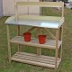 Wooden planting bench work station with metal top shelf and two lower shelves for organizing gardening tools and pots.