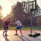 Adjustable portable basketball hoop with shatterproof backboard, suitable for outdoor use in various settings.