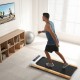 Under desk treadmill with remote control and LED display, featuring a natural rubber wood finish for home office.