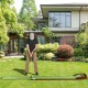 Golf putting mat with auto ball return, featuring two hole sizes, set up on a lawn for practice and training.