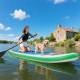 Inflatable 11 feet stand up paddle board with a non-slip deck, center fin, and a paddler enjoying a lake with a dog.