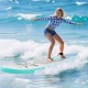 Young woman surfing on an 11 feet inflatable stand up paddle board with a non-slip deck in ocean waves.