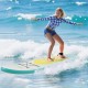 Young woman surfing on an 11 feet inflatable stand up paddle board with a non-slip deck in ocean waves.