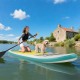 A girl paddles on an 11-foot inflatable stand-up paddle board with a dog, showcasing its stability and non-slip deck.