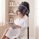 Salon standing hair dryer bonnet in use, featuring a swivel hood, adjustable temperature, and portable design for easy.