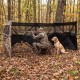 Pop-up hunting blind with camouflage pattern, featuring adjustable windows and dog door, ideal for 1-3 people in the.