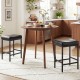 Set of 2 black counter height bar chairs with ergonomic saddle seats, ideal for kitchen islands or dining areas.