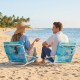 Low-profile folding beach chair with sponge padding and a vibrant tropical print, perfect for relaxing by the shore.