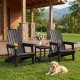 Two black HDPE Adirondack chairs with cup holders and wood-like texture, perfect for outdoor relaxation on the patio.