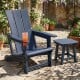 Blue outdoor Adirondack chair with a cup holder, featuring a curved backrest and wide armrests for enhanced comfort.