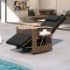 Black patio rattan swivel recliner chair with adjustable backrest, wood armrests, and side table for outdoor relaxation.
