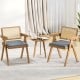 Set of 2 gray rattan accent chairs with padded cushions and rubber wood frames, perfect for dining or living room decor.