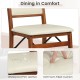Folding dining chair with padded seat, waterproof PVC leather, and walnut finish for comfortable dining.