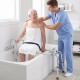 Sliding tub transfer bench with detachable armrests, adjustable height, and safety belt for secure bathing assistance.