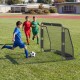 Kids playing soccer near a 6 ft x 4 ft metal frame goal post with net, perfect for backyard training and recreation.