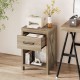 Natural nightstand showcasing a spacious drawer and open shelf, featuring protective foot pads and a stylish farmhouse.