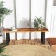 Solid acacia wood patio bench with metal legs, featuring a polished surface, ideal for contemporary outdoor seating.