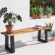Solid acacia wood patio bench with metal legs, featuring a polished surface, ideal for outdoor dining and decor.