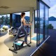 Magnetic elliptical machine cross trainer in action with adjustable seat and handlebars for customizable workouts at.