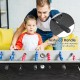 Close-up of the textured handle on a 48-inch wooden foosball table, ensuring a firm grip for better control during play.