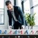 Competition-sized 48" wooden foosball table in black with ergonomic handles, ideal for game rooms and offices.