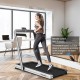 Folding treadmill with remote control and touch screen, offering 0.6-10.5mph speeds for fitness or under-desk use.
