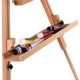 Close-up of the foldable wood tripod sketching easel's shelf with paint tubes, showcasing its smooth beech wood finish.