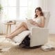 Beige swivel rocking chair in a cozy setting, featuring a cushioned back and gentle rocking motion for ultimate.