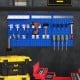 Wall-mounted pegboard kit in navy with tools organized, featuring 3 pegboards and 28 assorted hanging accessories for.