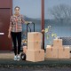 P-handle hand truck with foldable load plate, ideal for package delivery and moving, shown with boxes outdoors.