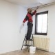 2-step ladder with wide anti-slip pedals, used for painting, featuring a heavy-duty metal frame and compact design.
