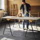 Heavy-duty sawhorse with steel folding legs, supporting up to 275 lbs, ideal for workspace setup and portability.