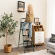 Folding 4-step ladder with tool tray, non-slip footpads, and a user safely reaching for a picture frame on the wall.