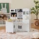 Wooden kid's corner kitchen playset in natural and white with stove, washing machine, and ample storage for imaginative.