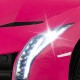 Close-up of bright LED headlights on the pink 12V Lamborghini kids ride-on sports car for fun and safety.