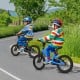 Two kids riding 16-inch magnesium alloy bikes with training wheels on a scenic path, perfect for ages 4 to 7.