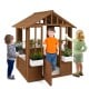 Outdoor playhouse featuring children engaging in role play through the door and windows, designed for kids over 2 years.
