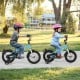 Two kids riding 14-inch bikes with training wheels, featuring adjustable seats and dual brake methods for safety.