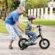 Child riding a 12-inch kids bike with adjustable features and training wheels, perfect for learning balance outdoors.