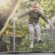 Trampoline safety net for 15/16 ft round trampolines, featuring durable PE material and adjustable straps for secure.
