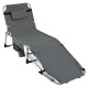 Portable gray tanning chair with face hole, adjustable backrest, and side pocket for sunbathing by the pool or beach.