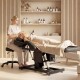 Tattoo chair in black with adjustable backrest and footrest, ideal for esthetician services like facials and nail art.