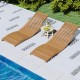 Teak wood folding chaise lounge chairs with slatted seats, perfect for poolside relaxation and outdoor comfort.